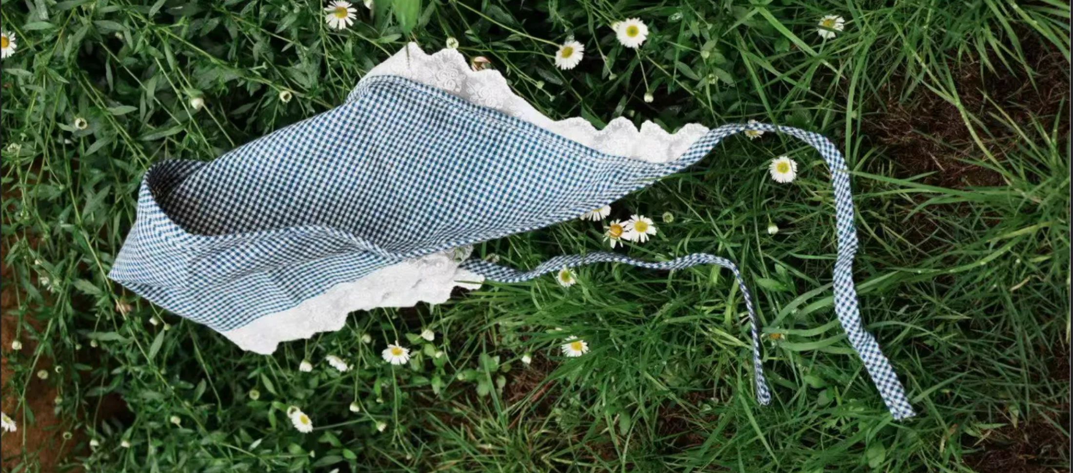 WFOND accessories in blue-and-white Chongming Tubu check, laid out on grass.